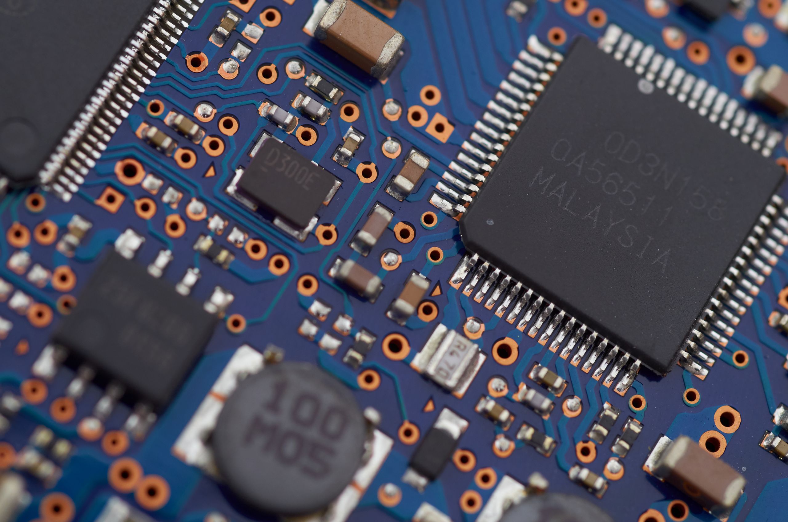 Close-up of a glowing blue electronic circuit board