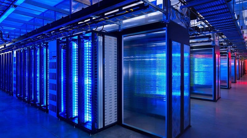 Server room racks lit by neon blue light